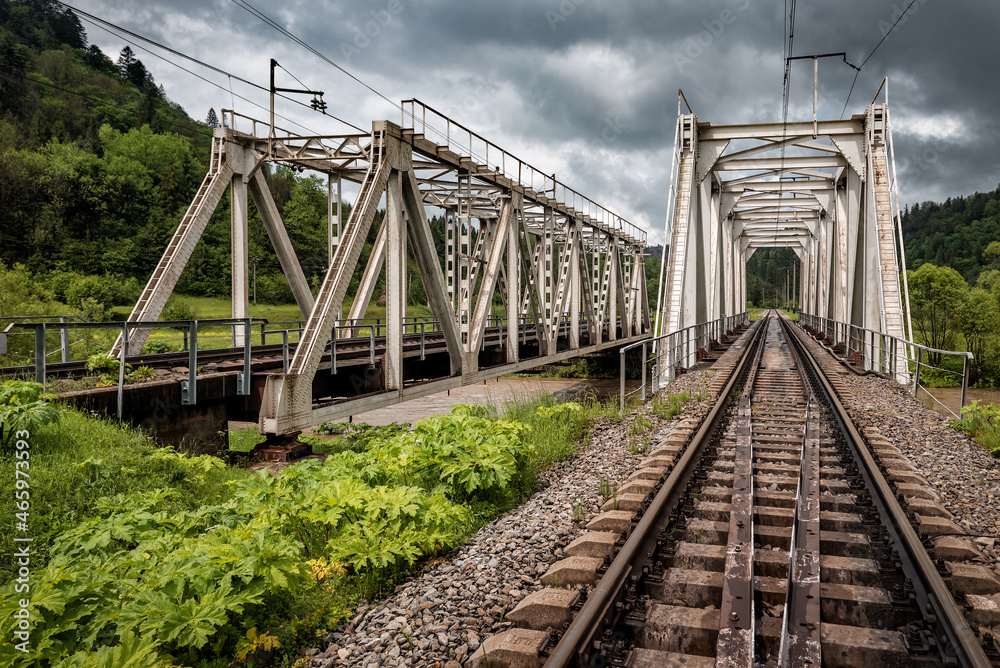 two railway bridges across the river in the mountains