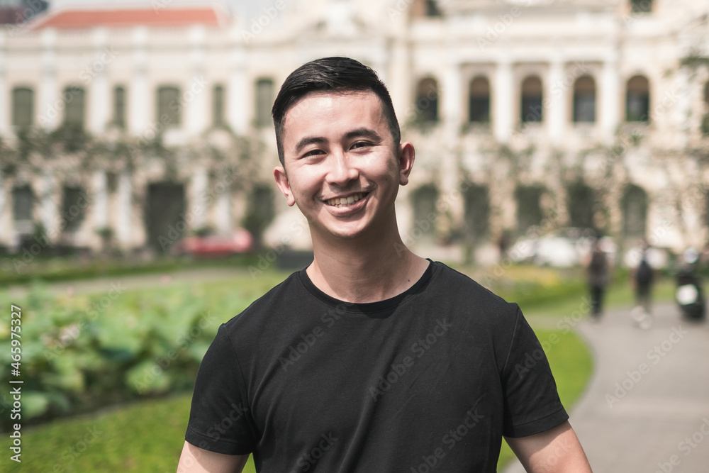 Portrait of asian young handsome man in casual clothing standing on the street and smiling. Asia, Chinese people, real life concept, sunny day