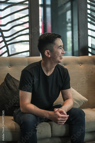 Asian young handsome man sitting in coffee shop, talking and smiling. chinese guy, millennials life, lifestyle in the big city, Modern Asia 