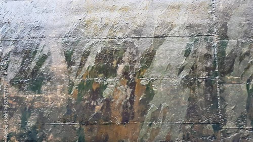 Textured surface of gray concrete wall with scratches and cracks