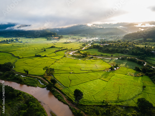 aerial view of paddy filed in small village among sunrise at Chiang mai, Thailand