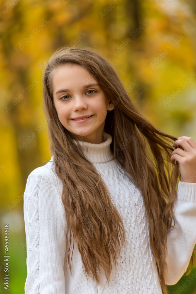 girl brunette child in white sweater in autumn in the park girl brunette child in white sweater in autumn in the park