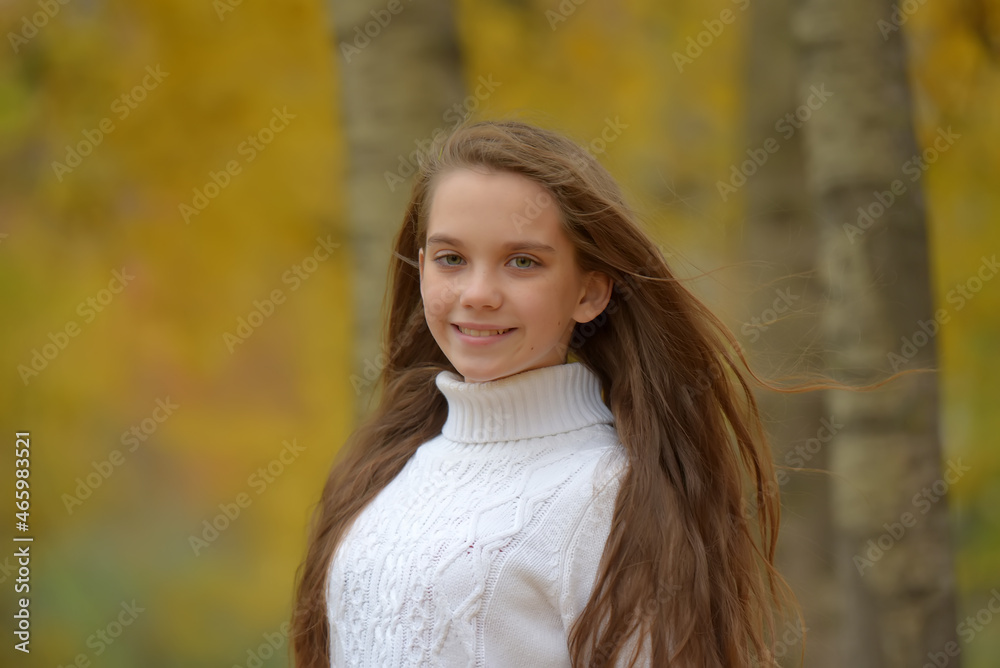 girl brunette child in white sweater in autumn in the park girl brunette child in white sweater in autumn in the park