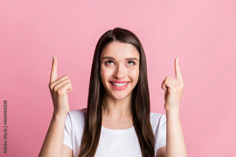 Portrait of attractive cheerful girl pointing up offer copy empty space solution advert ad isolated over pink pastel color background Portrait of attractive cheerful girl pointing up offer copy empty space solution advert ad isolated over pink pastel color background