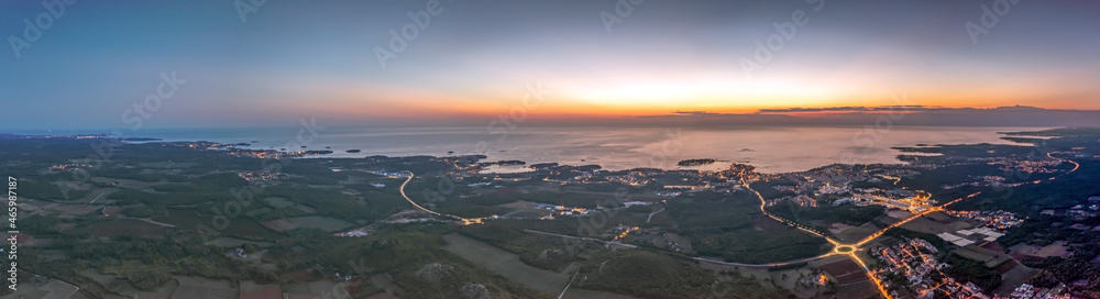 Drone panorama over Istrian Adriatic coast near Porec taken from high altitude at sunset