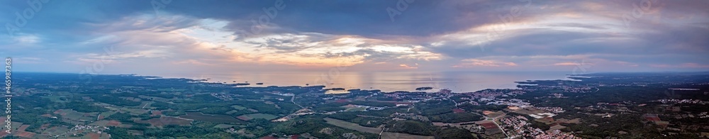 Drone panorama over Istrian Adriatic coast near Porec taken from high altitude at sunset