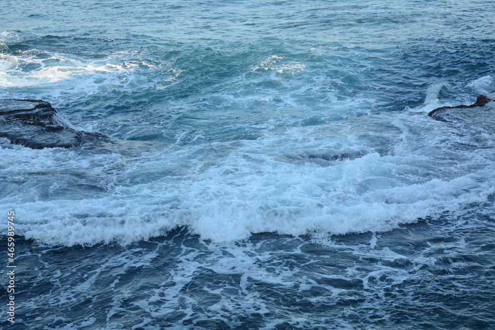 Sea Waves Crashing on the Rocks with White Foam. Swirling frothy foamy sea water over the rock near Akko(Acre) Israel Sea Waves Crashing on the Rocks with White Foam. Swirling frothy foamy sea water over the rock near Akko(Acre) Israel