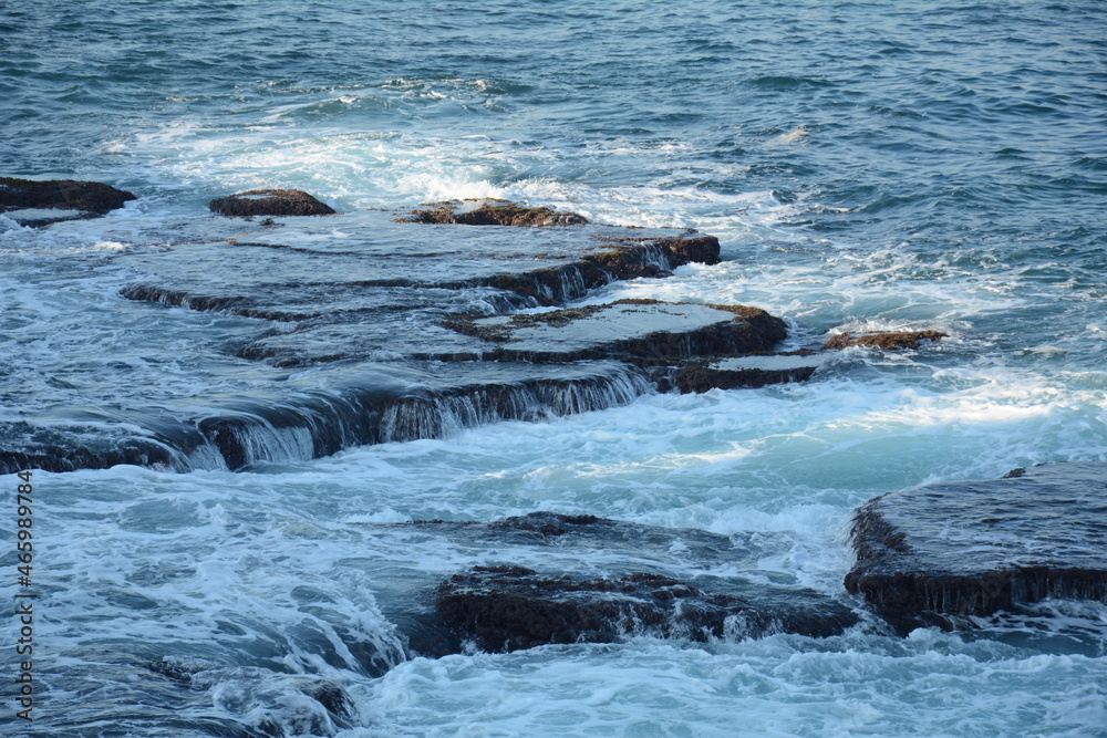 Sea Waves Crashing on the Rocks with White Foam. Swirling frothy foamy sea water over the rock near Akko(Acre) Israel Sea Waves Crashing on the Rocks with White Foam. Swirling frothy foamy sea water over the rock near Akko(Acre) Israel