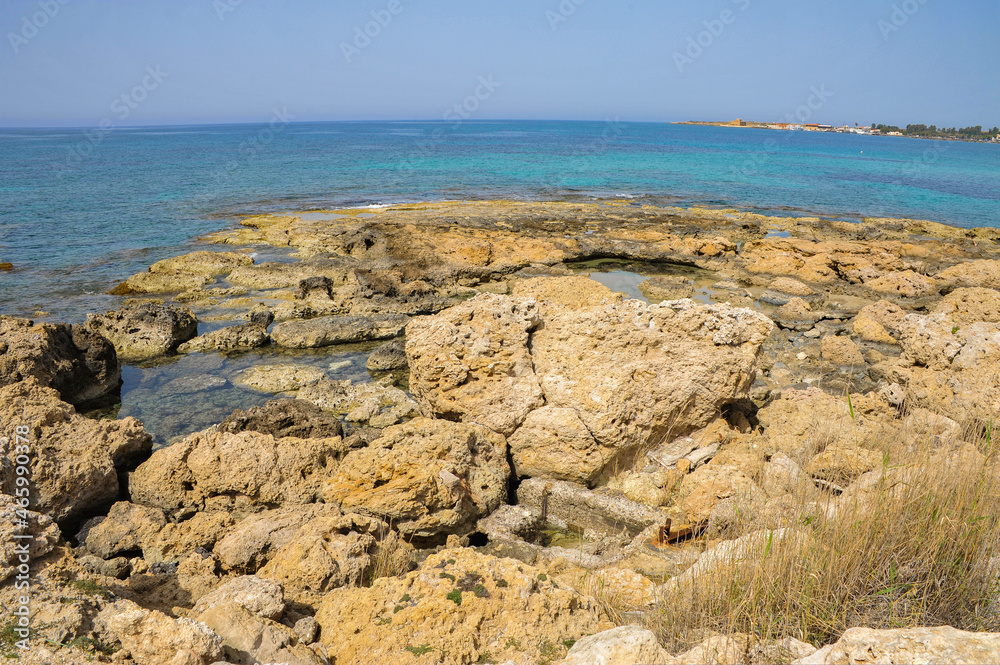 The charm of the spring coast of Paphos consists of the bright color of the sea, bizarre coastal rocks and a scattering of large and small blooming plants    