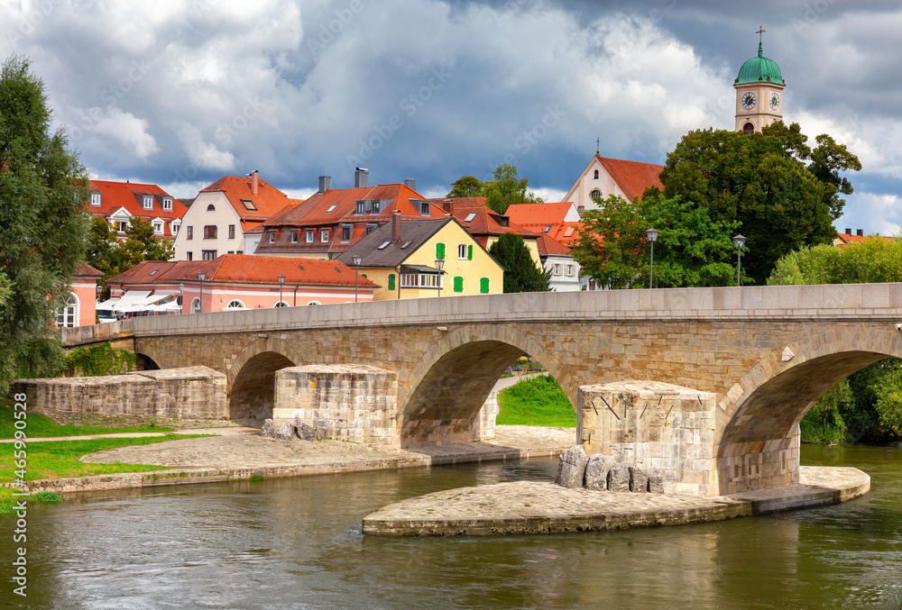 Regensburg. Embankment and old stone bridge over the Danube river.
