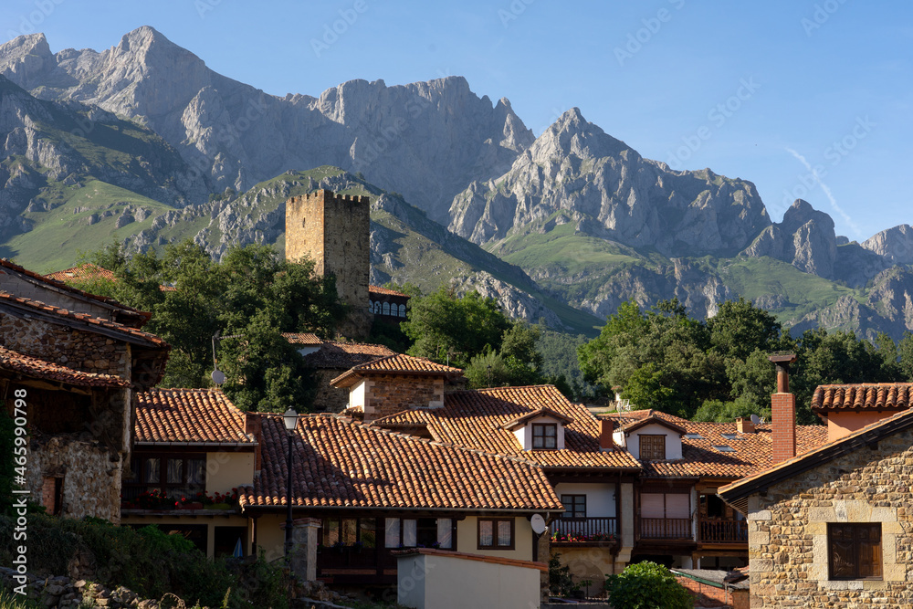 View of the medieval village of Mogrovejo with the castle tower and the European Peaks in the background