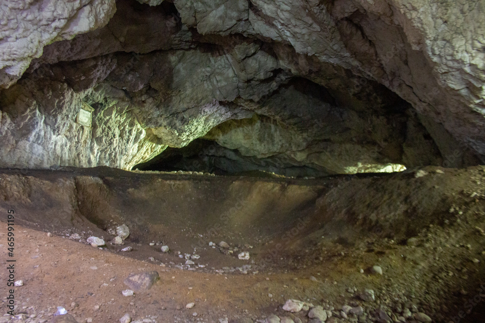 Cave with dim light shining in Cave with dim light shining in