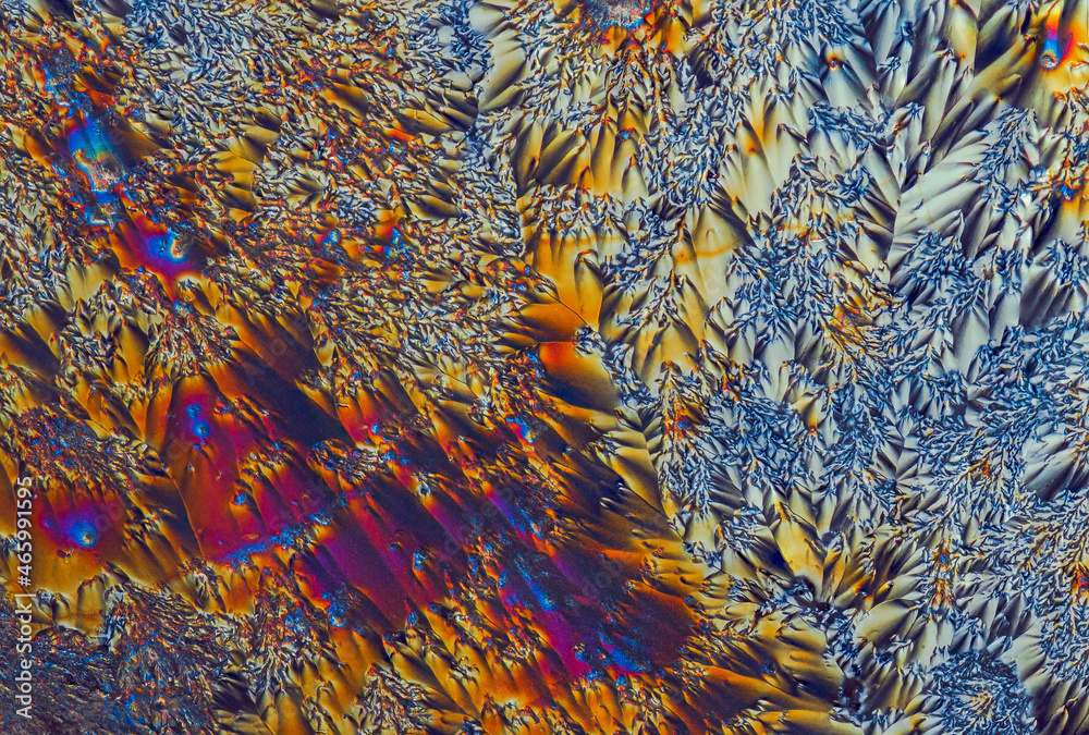 Extreme macro photograph of Vitamin C crystals forming abstract modern art patterns, when illuminated with polarized light, under a microscope objective with 10x magnification Extreme macro photograph of Vitamin C crystals forming abstract modern art patterns, when illuminated with polarized light, under a microscope objective with 10x magnification