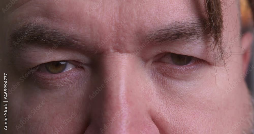 Adult man with a serious expression looking at the camera. Close-up Adult man with a serious expression looking at the camera. Close-up