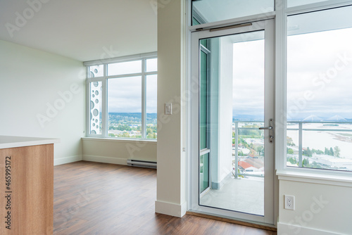 Modern, bright, clean empty kitchen interior with stainless steel appliances in a luxury house.