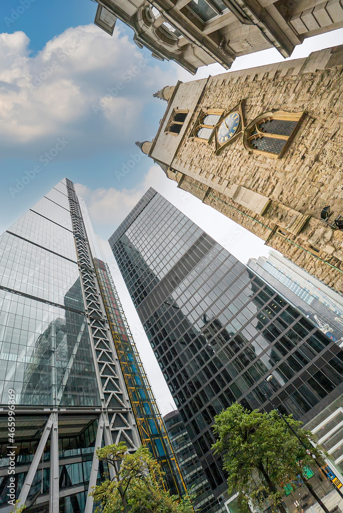Fototapeta premium There are office buildings, skyscrapers, churches in the business against the background of blue sky and white clouds district of London, UK