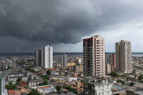 Tropical storm in formation near river in big city of Northern Brazil.