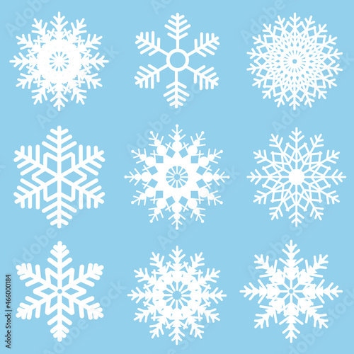 Winter set of white snowflakes isolated on light blue background. Snowflake icons. Snowflakes collection for design Christmas and New Year banner and cards.
