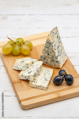 blue cheese on wooden board with grapes