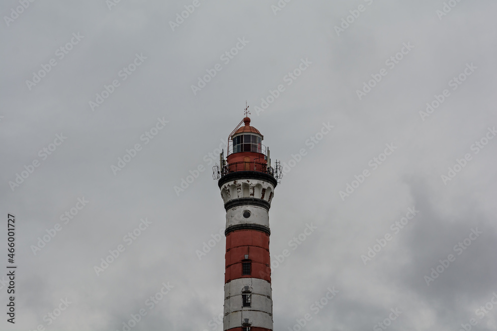 Osinovets Lighthouse, Lake Ladoga. High lighthouse in cloudy weather. White-red lighthouse. Osinovets Lighthouse, Lake Ladoga. High lighthouse in cloudy weather. White-red lighthouse.