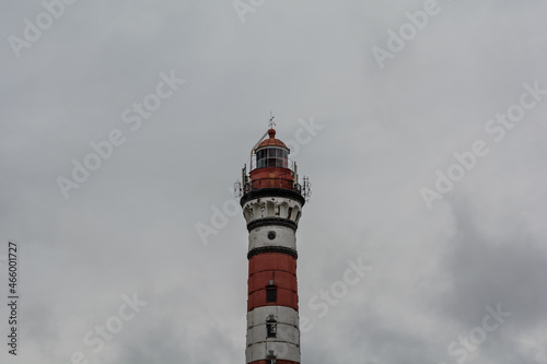 Osinovets Lighthouse, Lake Ladoga. High lighthouse in cloudy weather. White-red lighthouse.