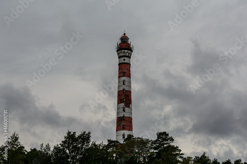 Osinovets Lighthouse, Lake Ladoga. High lighthouse in cloudy weather. White-red lighthouse.
