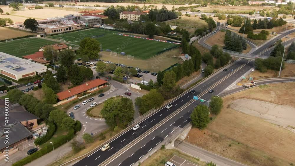 Italian landscape with highway road and speeding vehicles, aerial drone view