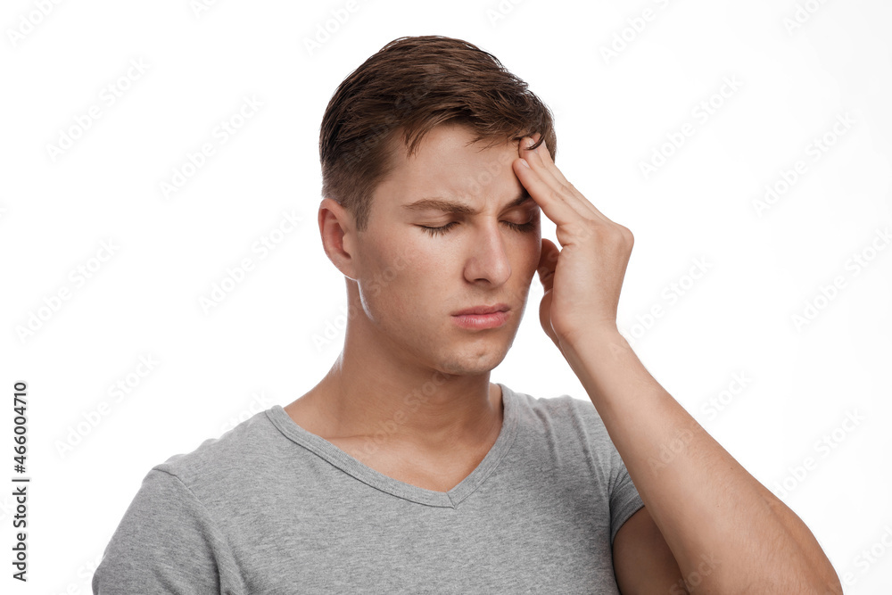 Despaired sad attractive young caucasian guy suffering from headache, touching forehead, isolated on white background Despaired sad attractive young caucasian guy suffering from headache, touching forehead, isolated on white background