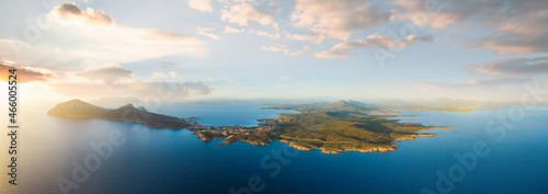 View from above  aerial shot  stunning panoramic view of Golfo Aranci during a beautiful sunrise. Golfo Aranci is a village that extends along a strip of land into turquoise sea. Sardinia  Italy.
