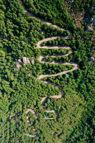 View from above, stunning aerial view of a serpentine road surrounded by green pine trees. Mount Limbara (Monte Limbara) Sardinia, Italy. photo