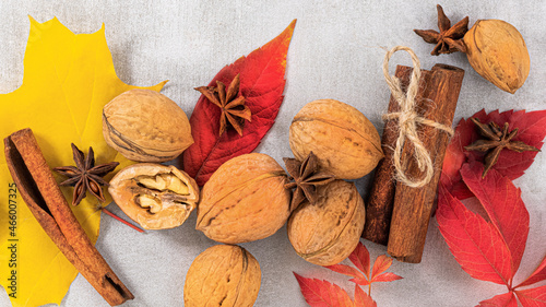 autumn background. Autumn leaves, walnuts and cinnamon sticks