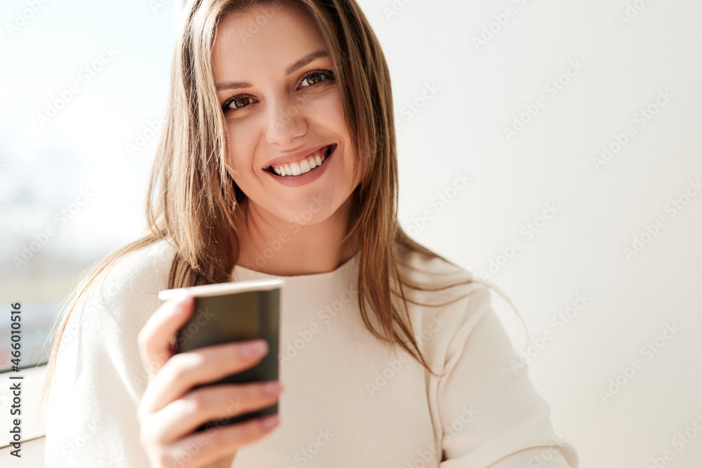 Content woman with cup of coffee in morning Content woman with cup of coffee in morning