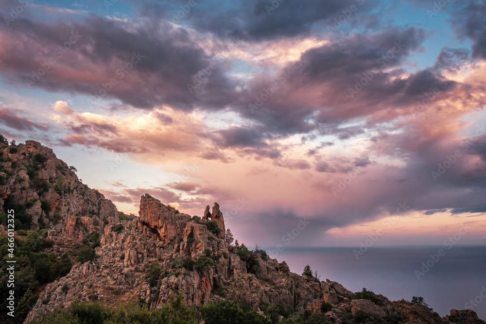 Dramatic morning sky behind the heart shaped hole in the rock of the Calanches, a UNESCO world heritage site in Corsica Dramatic morning sky behind the heart shaped hole in the rock of the Calanches, a UNESCO world heritage site in Corsica