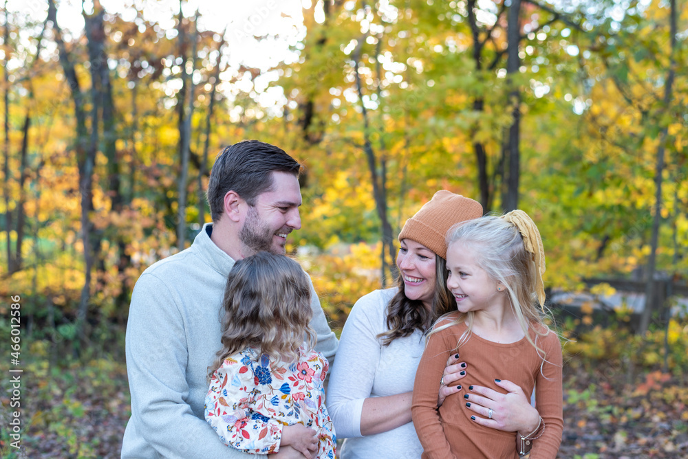 Fototapeta premium Young family outdoors in autumn