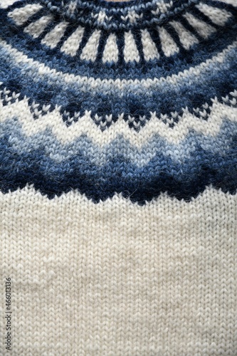 Close up of Icelandic sheep's wool knitted sweater, or lopapeysa, in white and blue. 