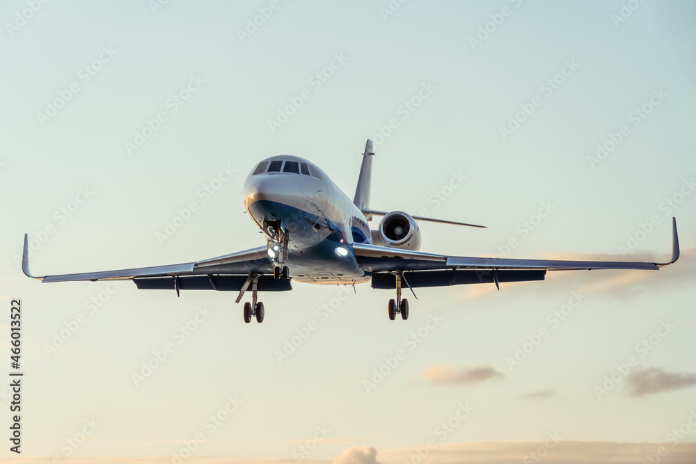 Close-up of a private plane against a beautiful gentle sky with clouds at sunset