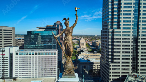 Aerial of Soldiers and Sailors Monument statue at top straight on with Indianapolis downtown in background photo