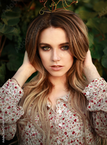 Beautiful blonde young woman in simple vintage dress. Close up portrait of smiling girl at sunset