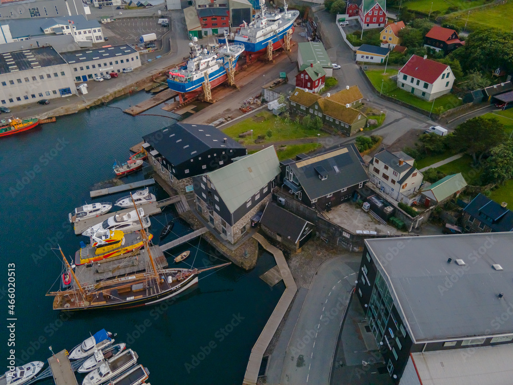 Beautiful aerial view of the City of Torshavn Capital of Faroe Islands- View of Cathedral, colorful buildings, marina, suburbs and Flag