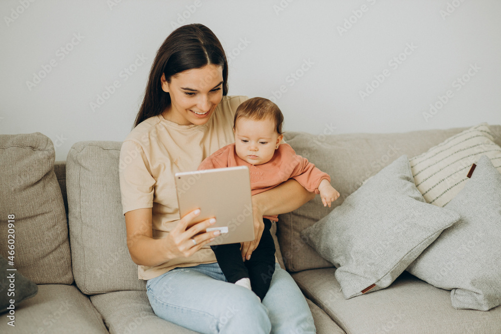 Mother with her bbay girl using tablet at home Mother with her bbay girl using tablet at home