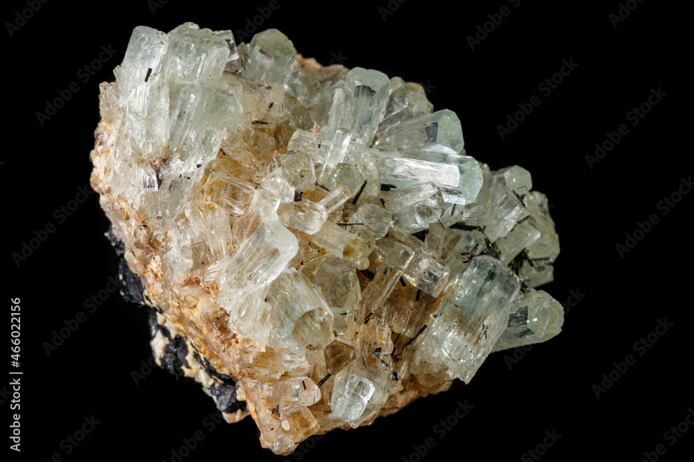 Macro mineral stone crystals Aquamarine in rock on a black background