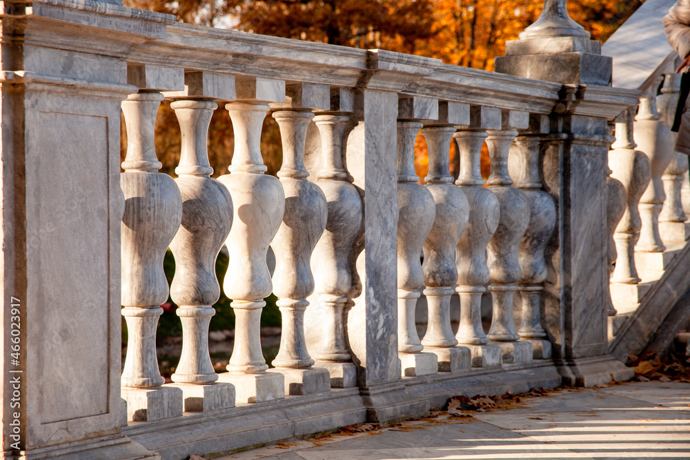 the fence is made of gray columns. granite balusters. part of the bridge is made of granite. gray fence. decorative elements of railings