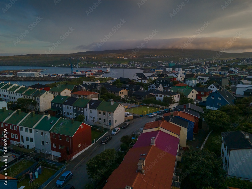 Naklejka premium Beautiful aerial view of the City of Torshavn Capital of Faroe Islands- View of Cathedral, colorful buildings, marina, suburbs and Flag