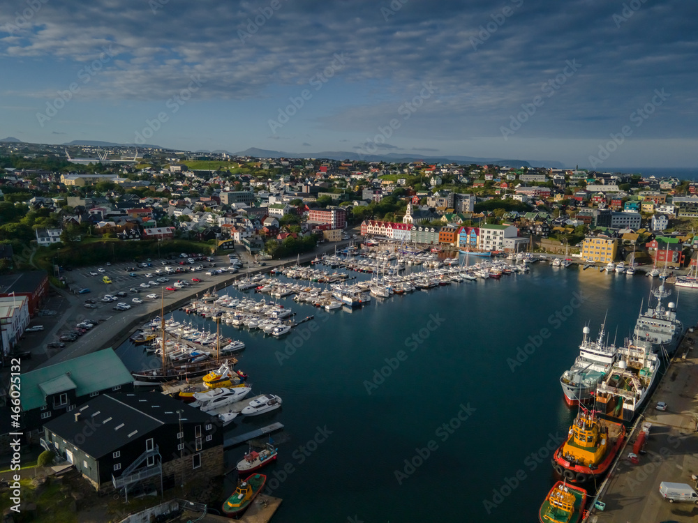 Beautiful aerial view of the City of Torshavn Capital of Faroe Islands- View of Cathedral, colorful buildings, marina, suburbs and Flag