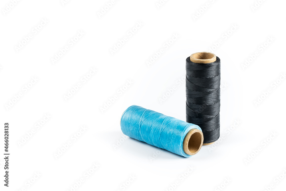 Coils of colored threads on a white background. Waxed sewing thread for leather crafts. Coils of colored threads on a white background. Waxed sewing thread for leather crafts.