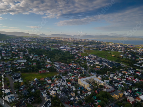 Beautiful aerial view of the City of Torshavn Capital of Faroe Islands- View of Cathedral, colorful buildings, marina, suburbs and Flag