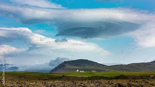 4k video time lapse with a magnificent lenticular cloud forming above a mountains peak.