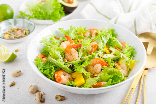 Grilled shrimp salad with avocado, mango, lettuce and pistachios, dressed with lime. Healthy food. Ketogenic diet.