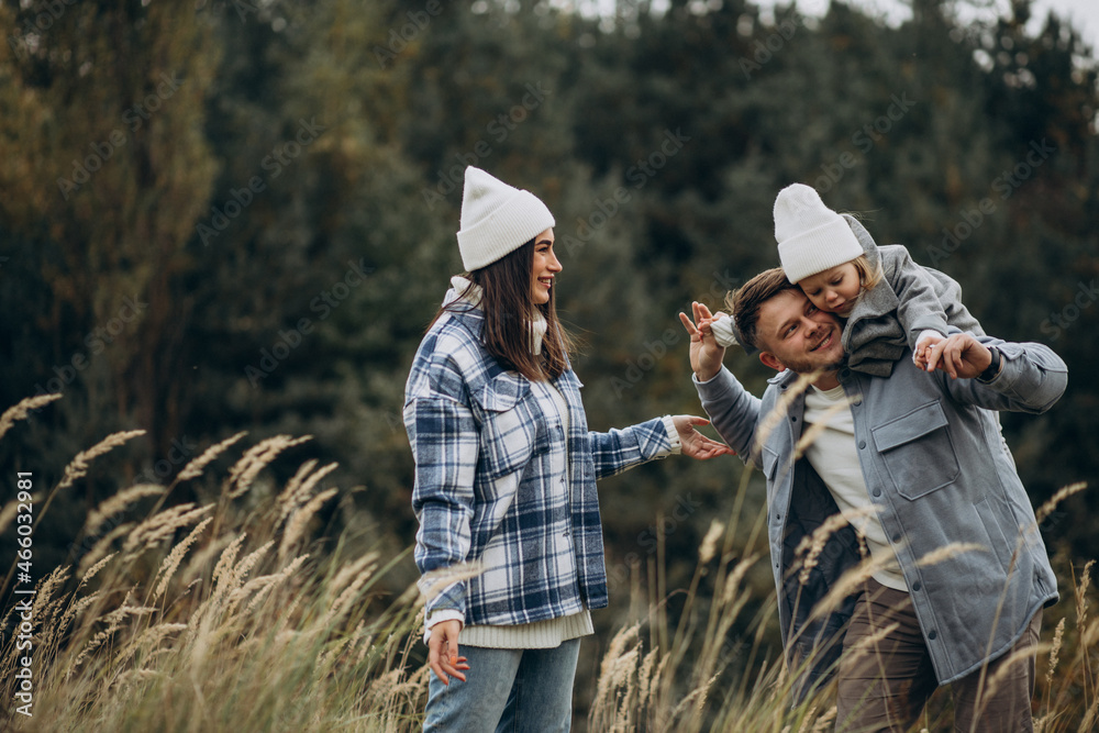 Family with little daughter together in autumnal weather having fun Family with little daughter together in autumnal weather having fun