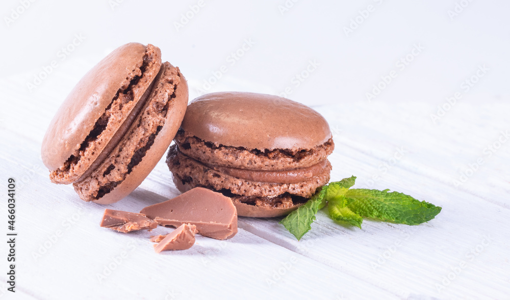 Macaroons with Sweet Chocolate on White Wooden Table Macaroons with Sweet Chocolate on White Wooden Table